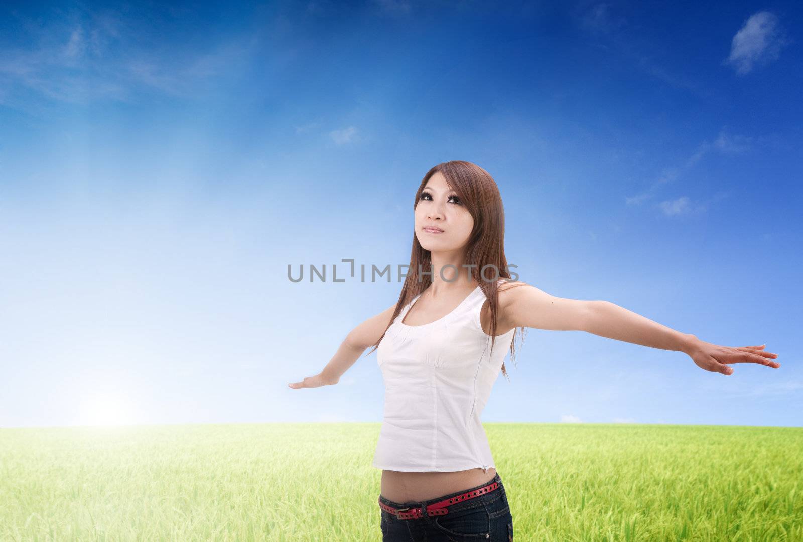 asian girl freedom concept photo on green paddy grass field 