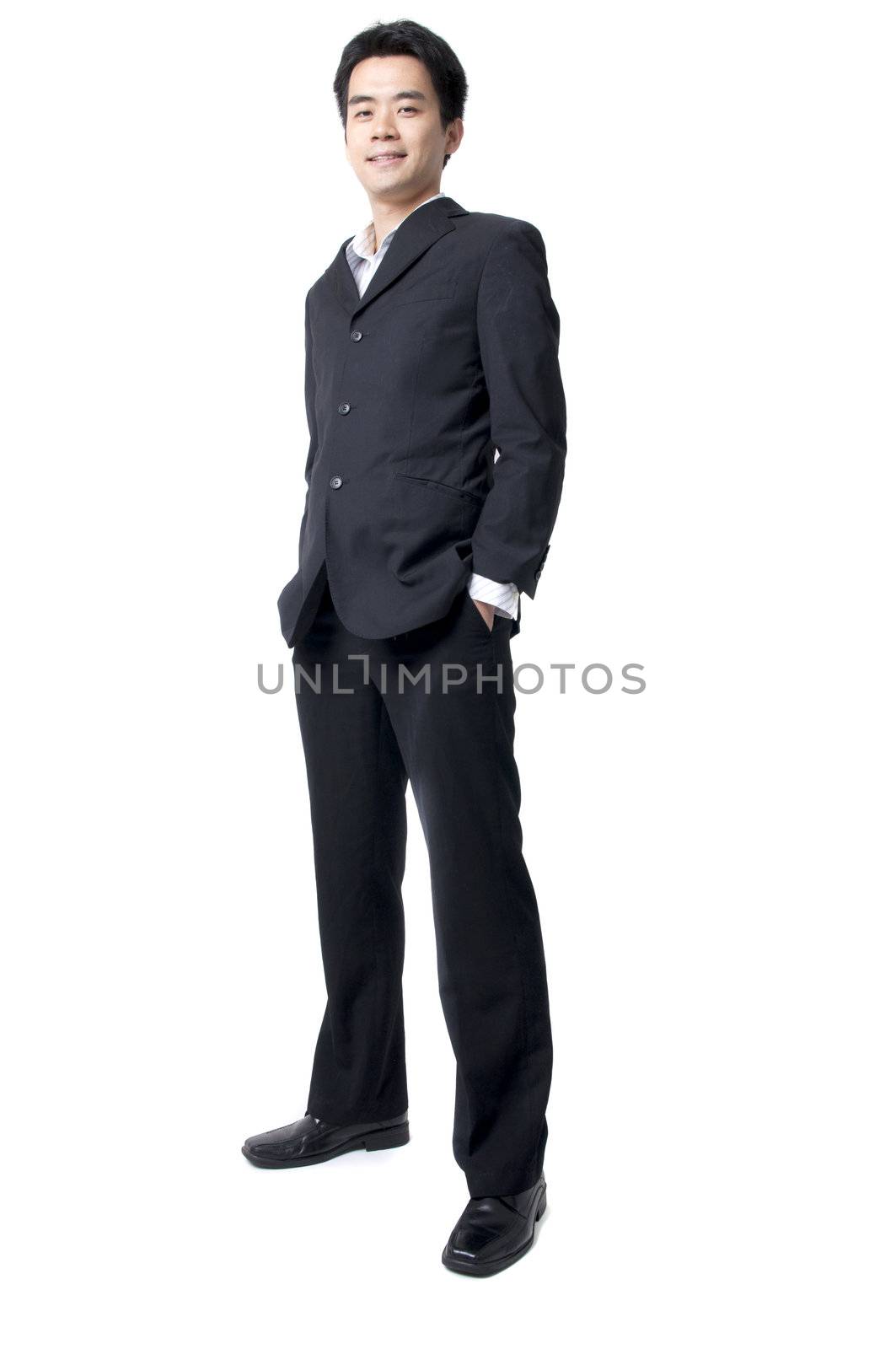 Full body of a smiling young Asian executive standing against isolated white background 