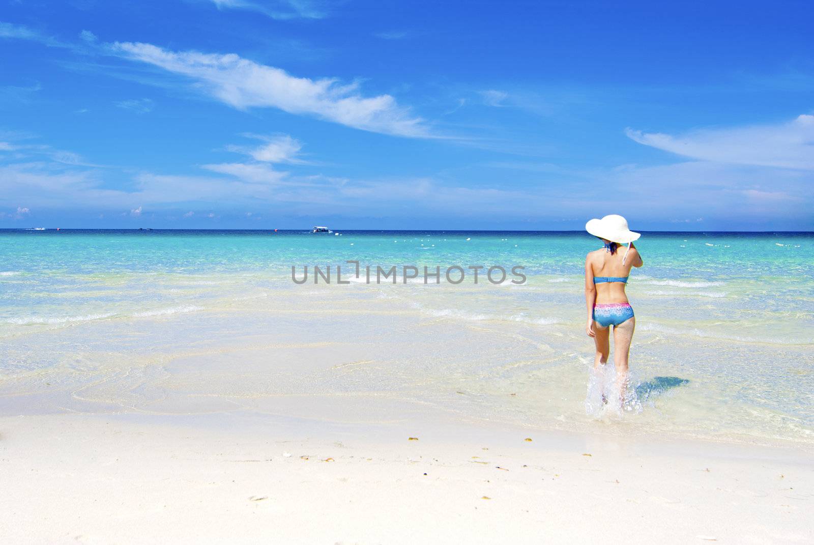 asian girl in bikini with blue beach