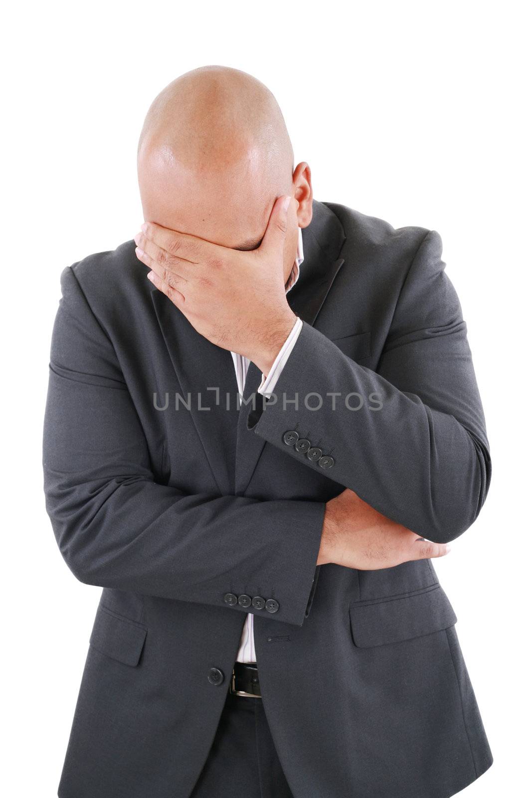 Portrait of a young business man looking depressed from work iso by dacasdo