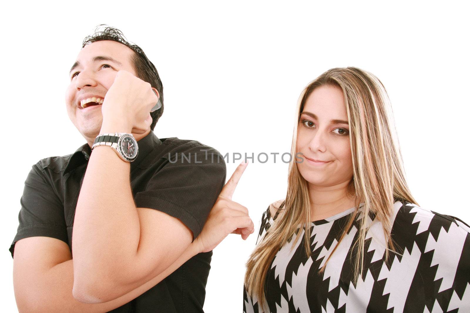 A woman not happy with what her boyfriend is laughing about on his phone.