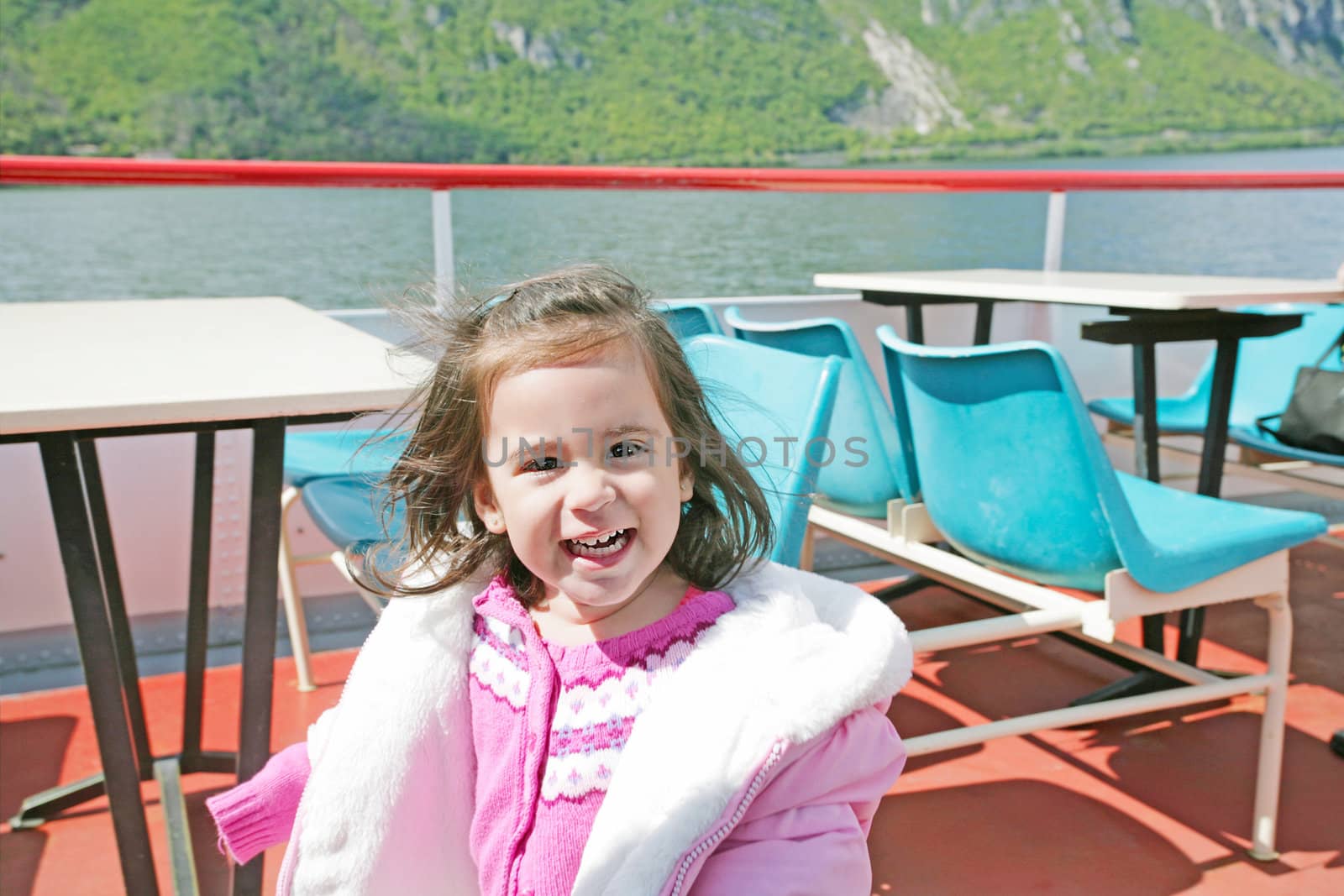 playful pretty little girl on sail boat in Lugano by dacasdo