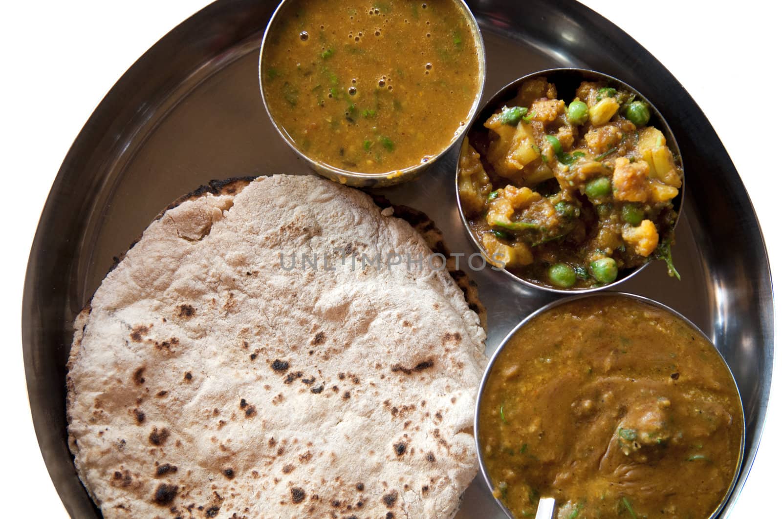 Traditional Indian cuisine vegetarian thali served in small bowls on a round tray. 