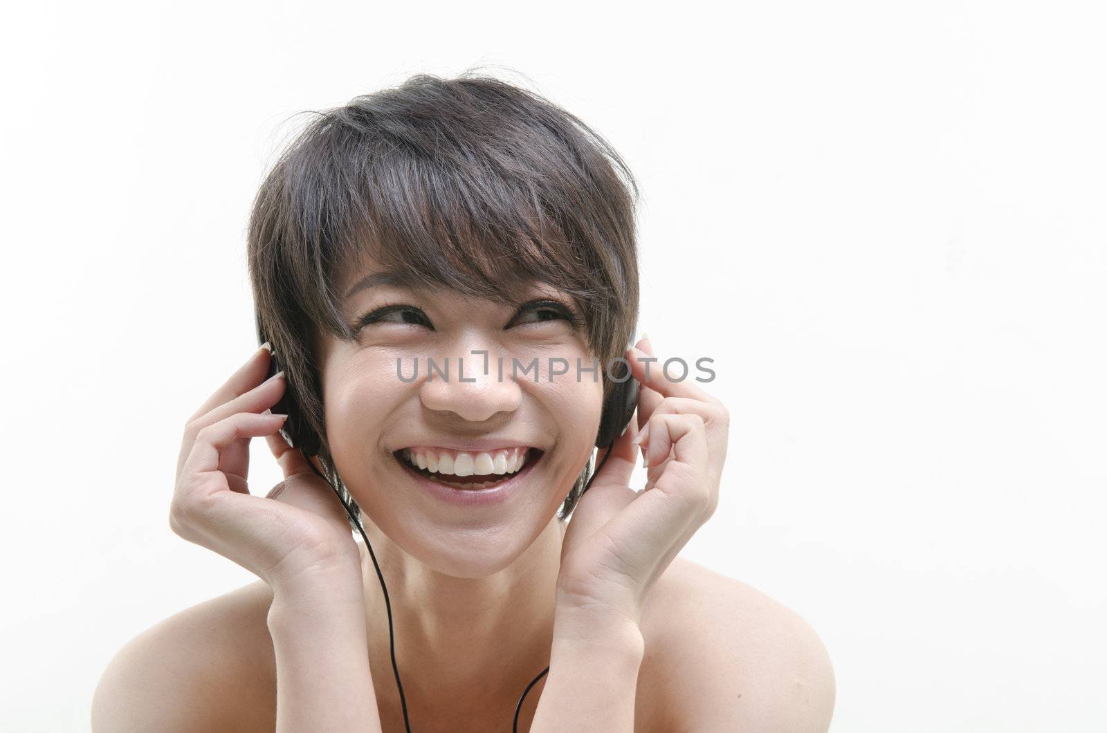 asian girl with earbud smiling whil istening to music