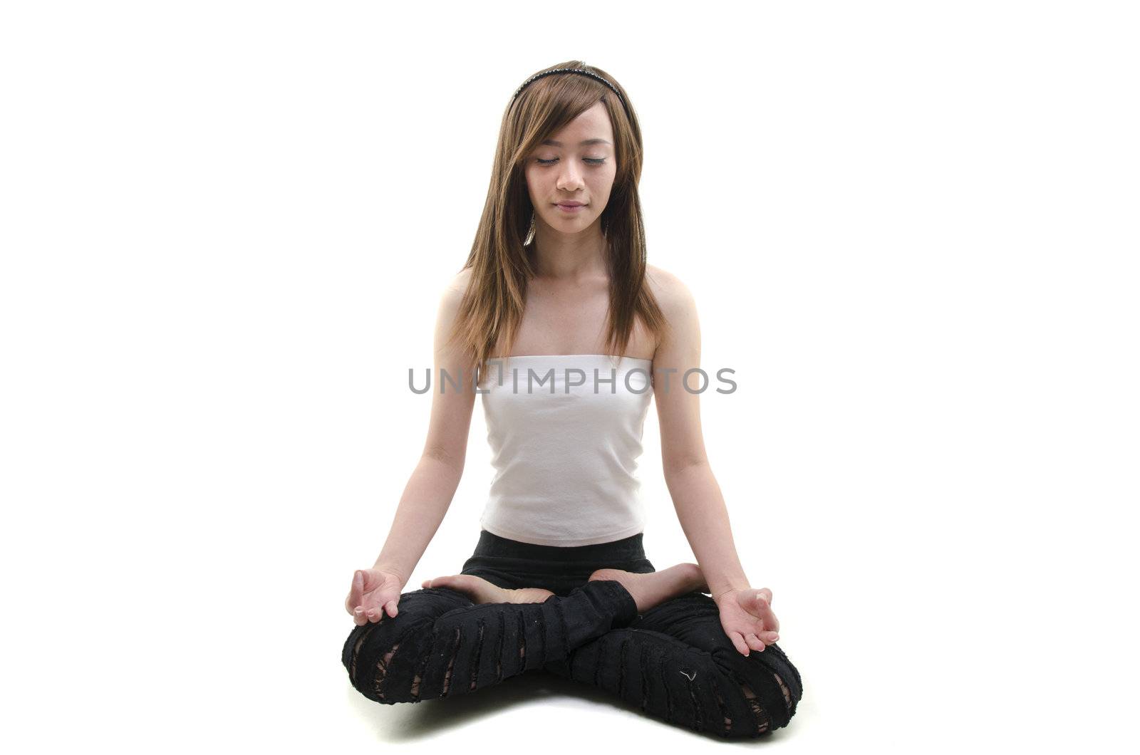 alternative looking asian girl performing yoga with white background