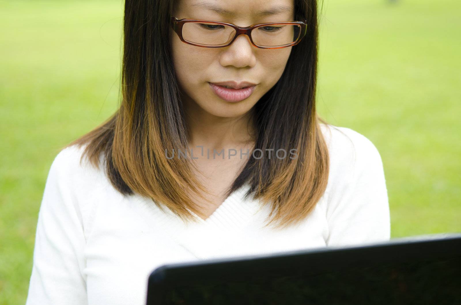 asian girl using laptop on outdoor