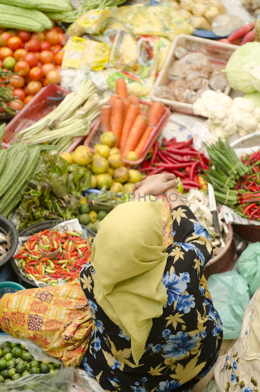 Vegetable market. Muslim woman selling fresh vegetables at Siti Khadijah Market market in Kota Bharu Malaysia. 