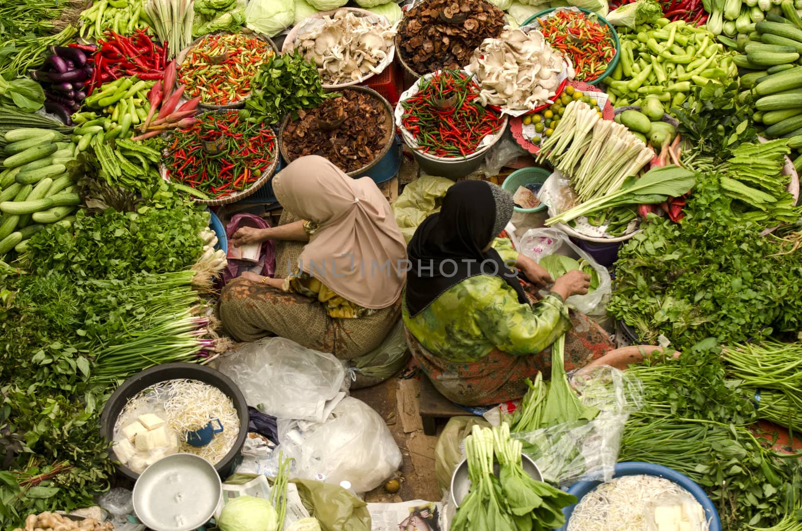Vegetable market. Muslim woman selling fresh vegetables at Siti Khadijah Market market in Kota Bharu Malaysia. 