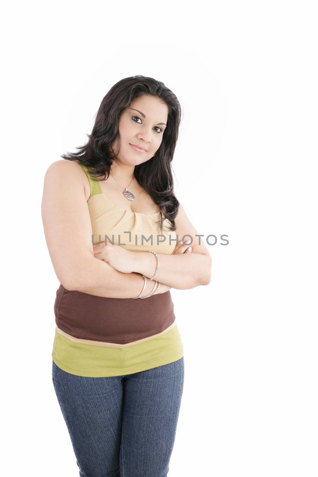 Portrait of an attractive young woman standing with her hand folded against white background