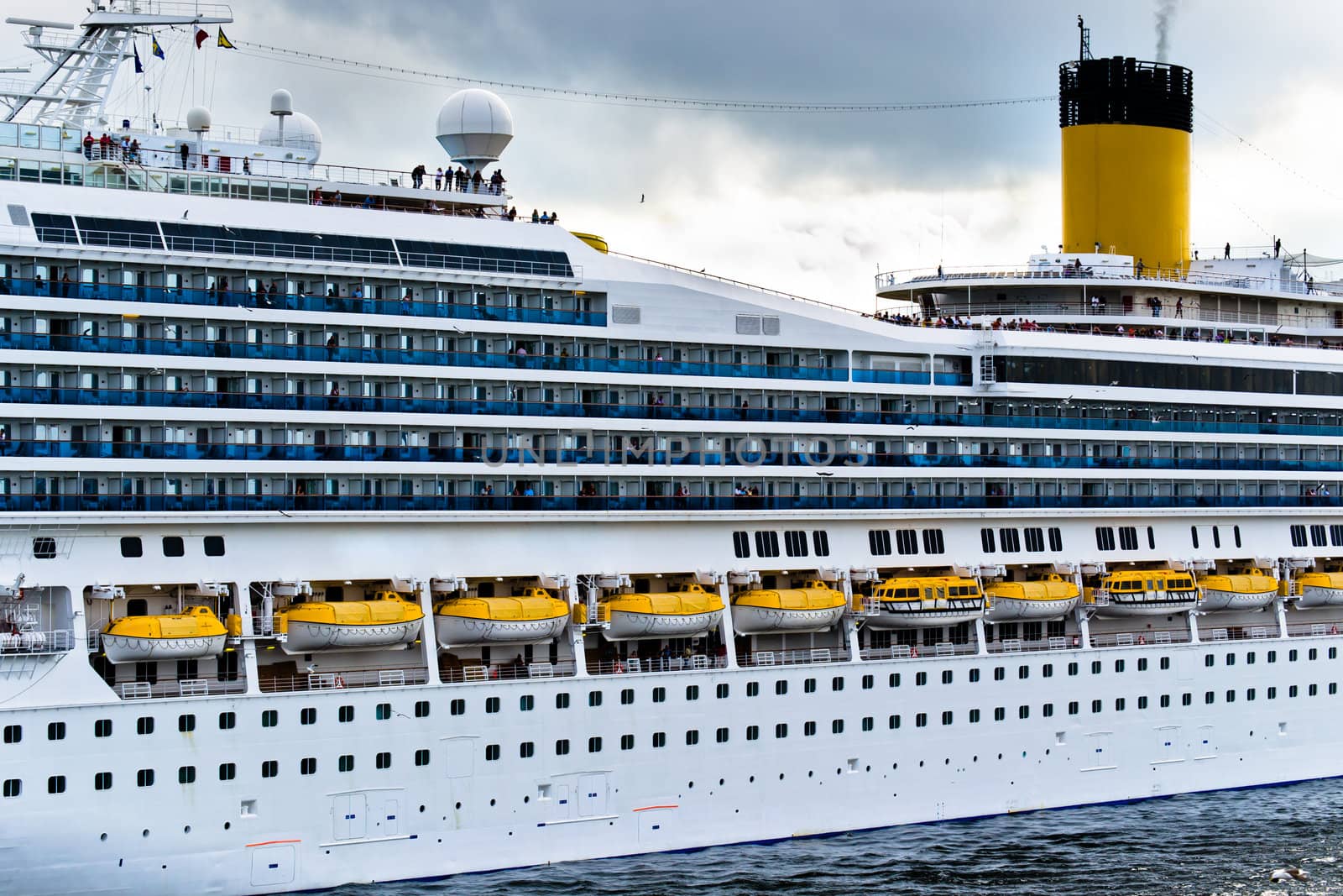 Large ferry on trip at open sea, part view from side