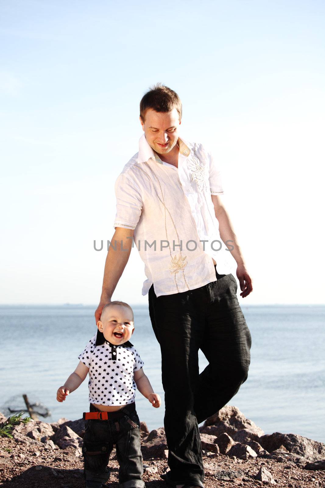 father and son walking on grass