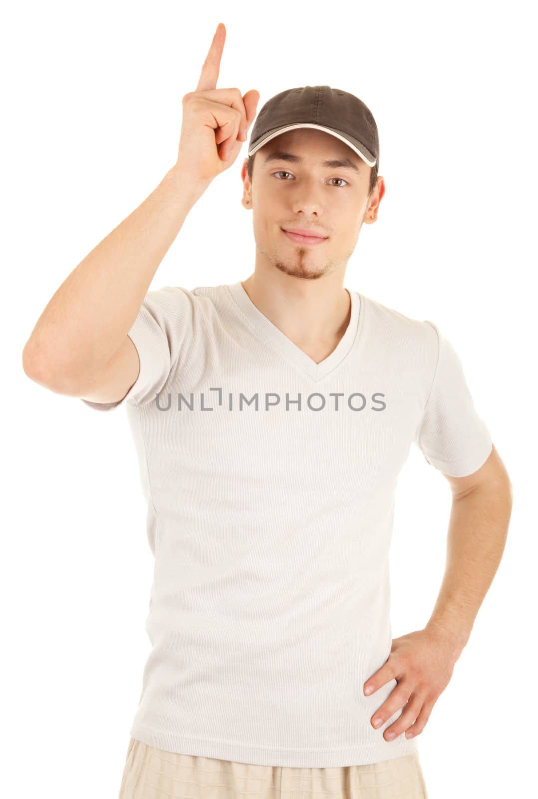 Casual young man in a hat is pointing up. Isolated on white.