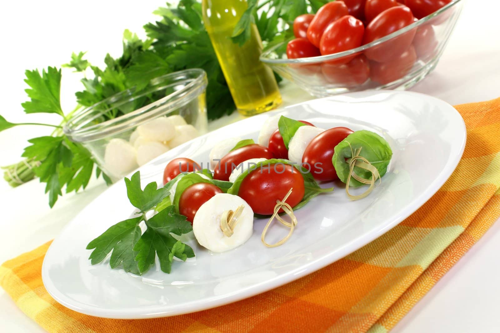 small skewers with mozzarella, tomato and basil