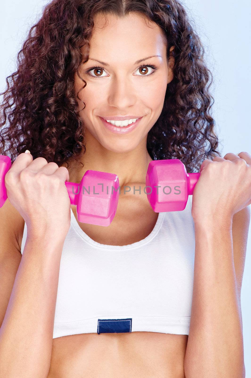 Young pretty woman doing fitness exercise with weight