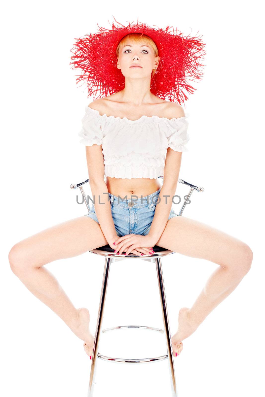 Woman with red hat sitting on the chair, isolated on white