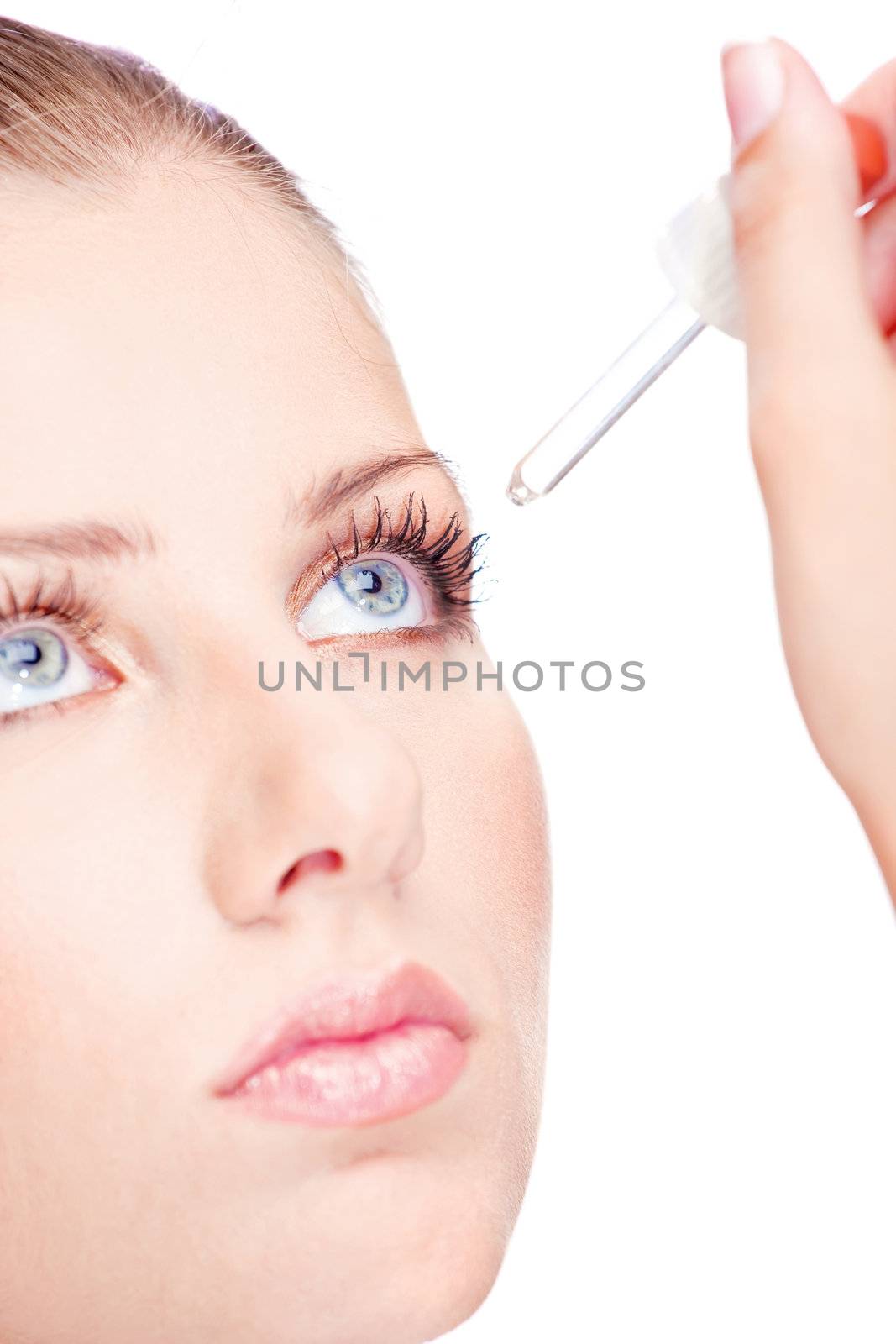 Woman with pipette putting drops in eye