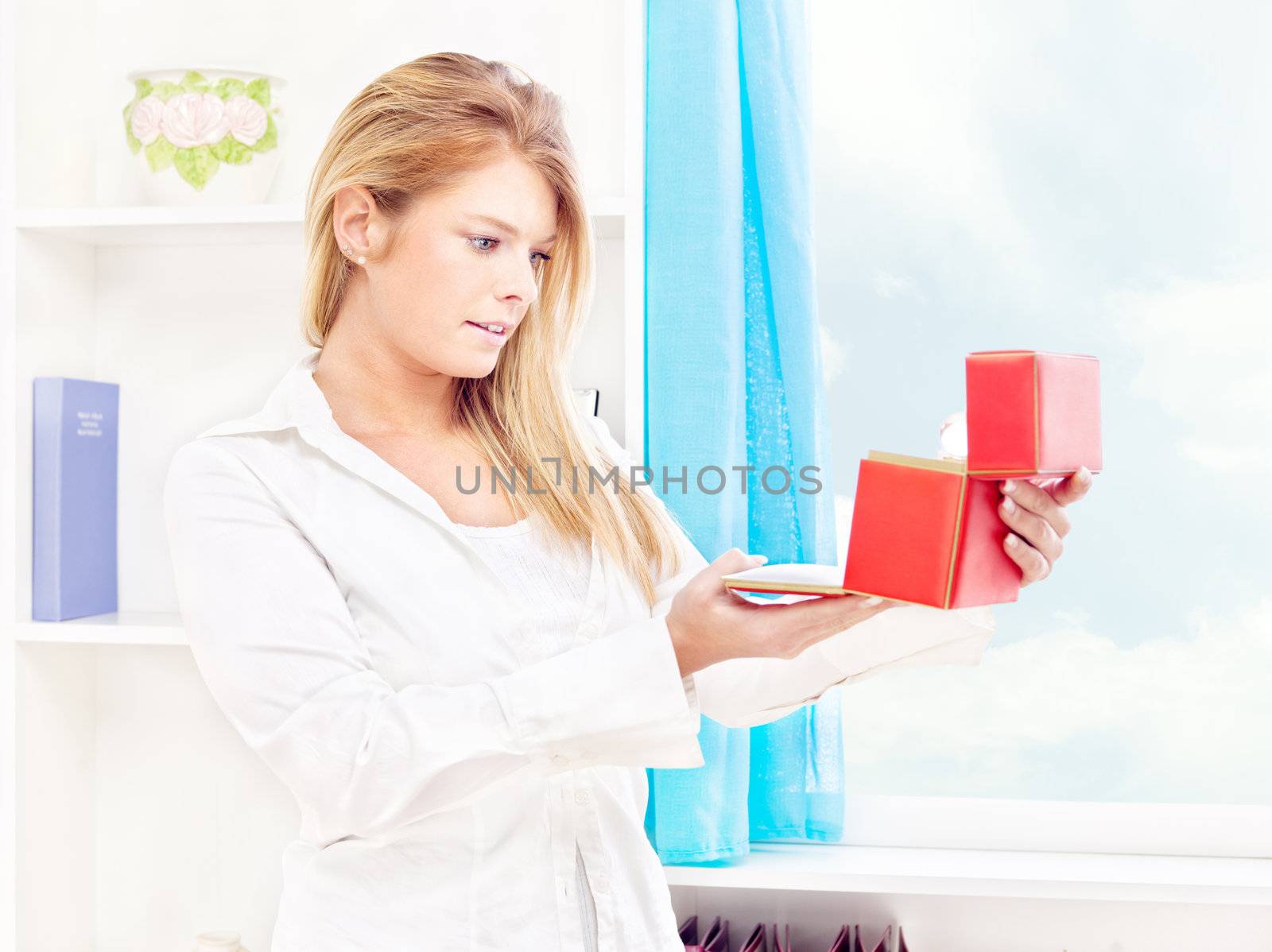 woman opening fancy box at home by imarin