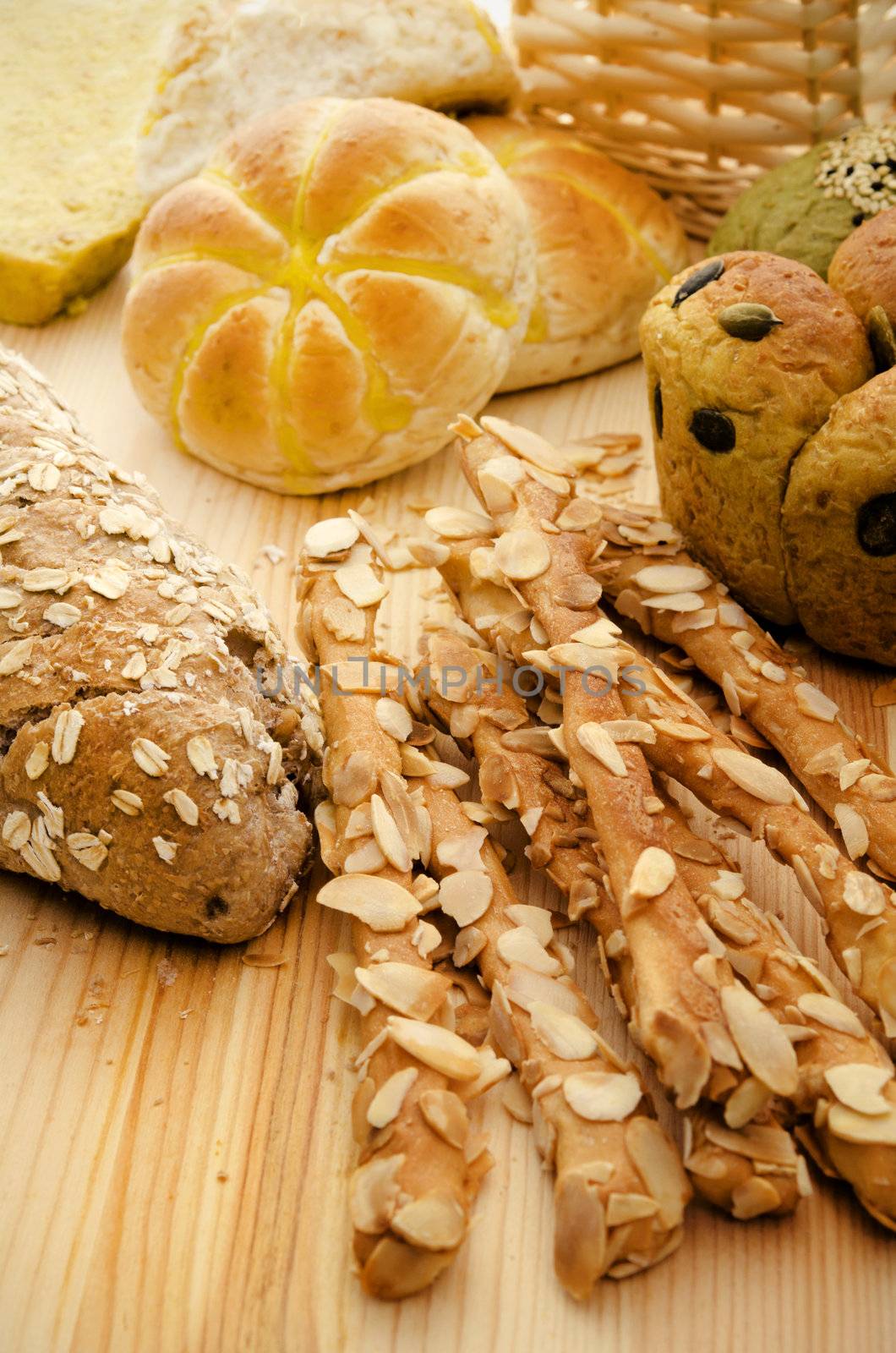 Variety of Organic Breads on plank background ,golden lights were used