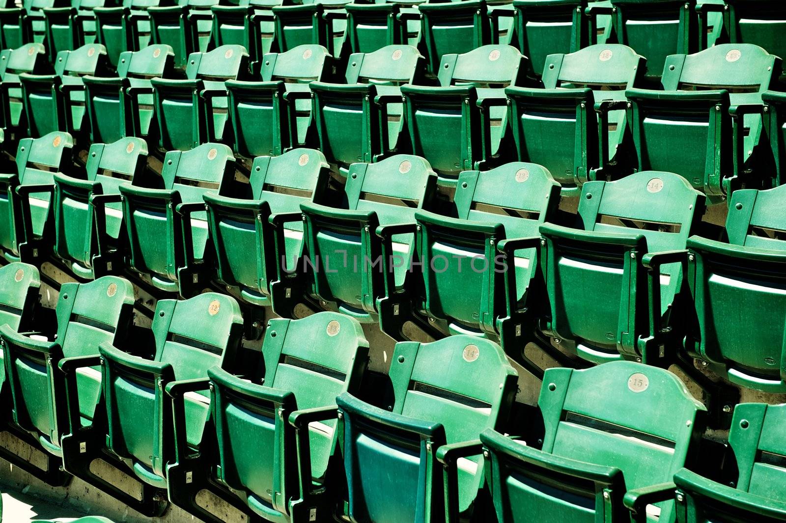 Several rows of green folding seats in a Major League baseball stadium