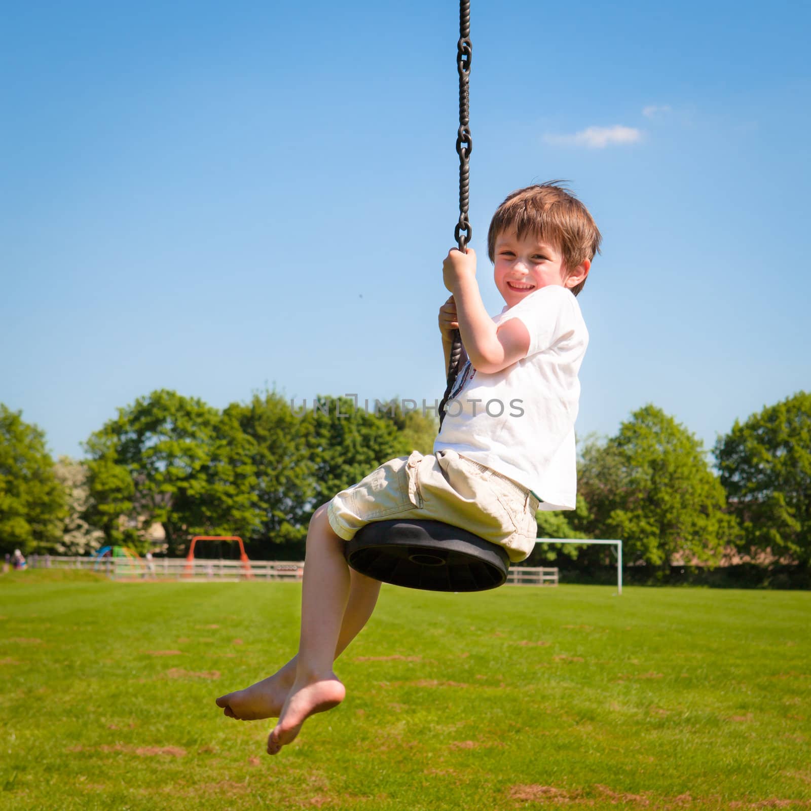 A young boy playing on a zip wire