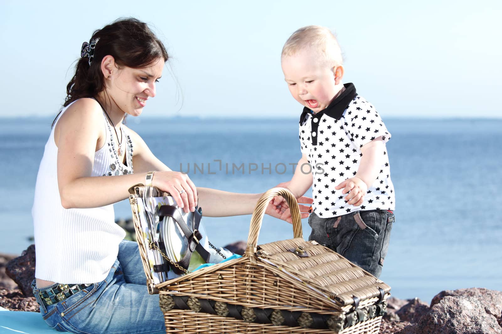 happy mother and son on picnic near sea