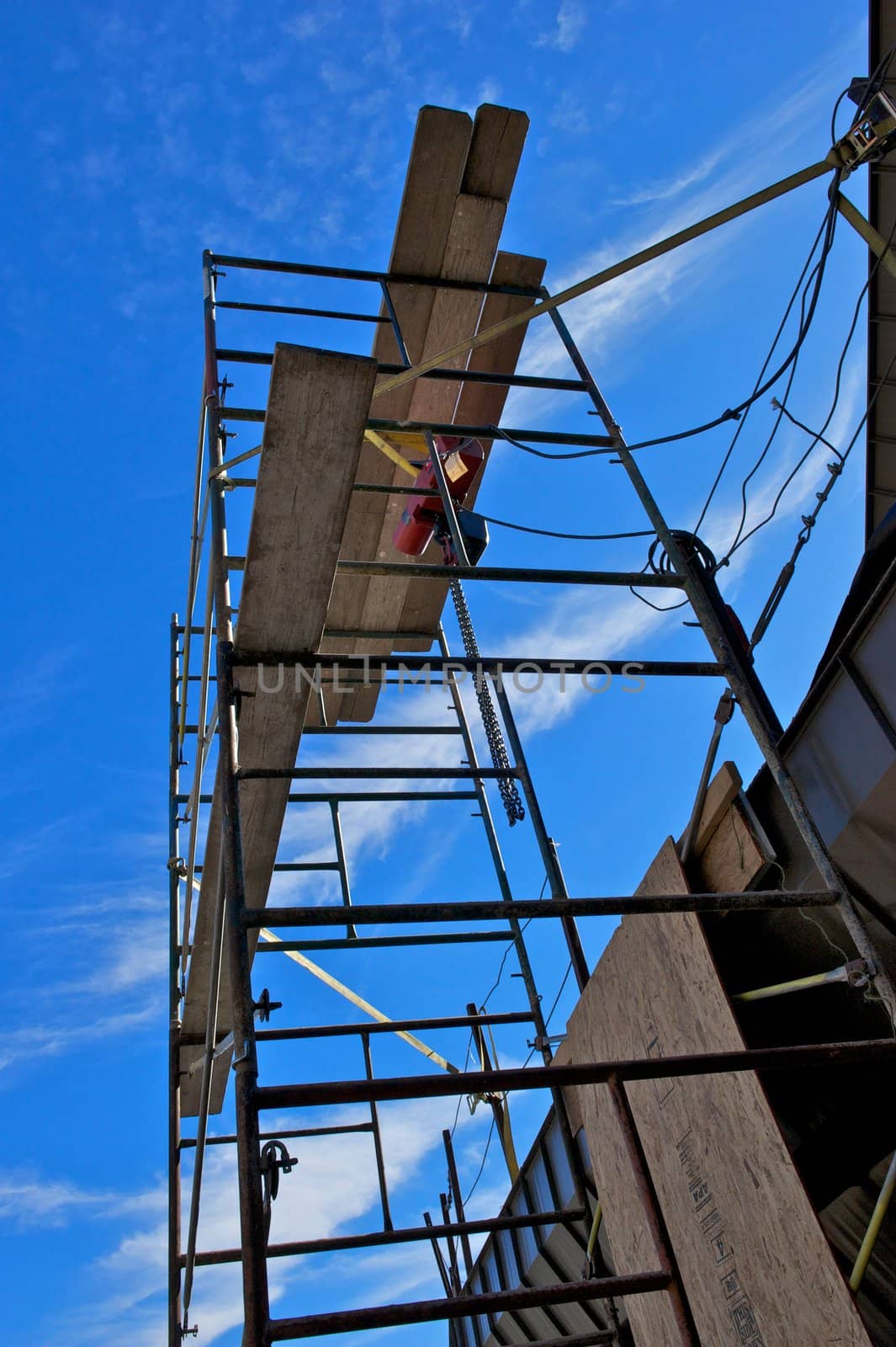 A set of construction scaffolding set against a deep blue sky