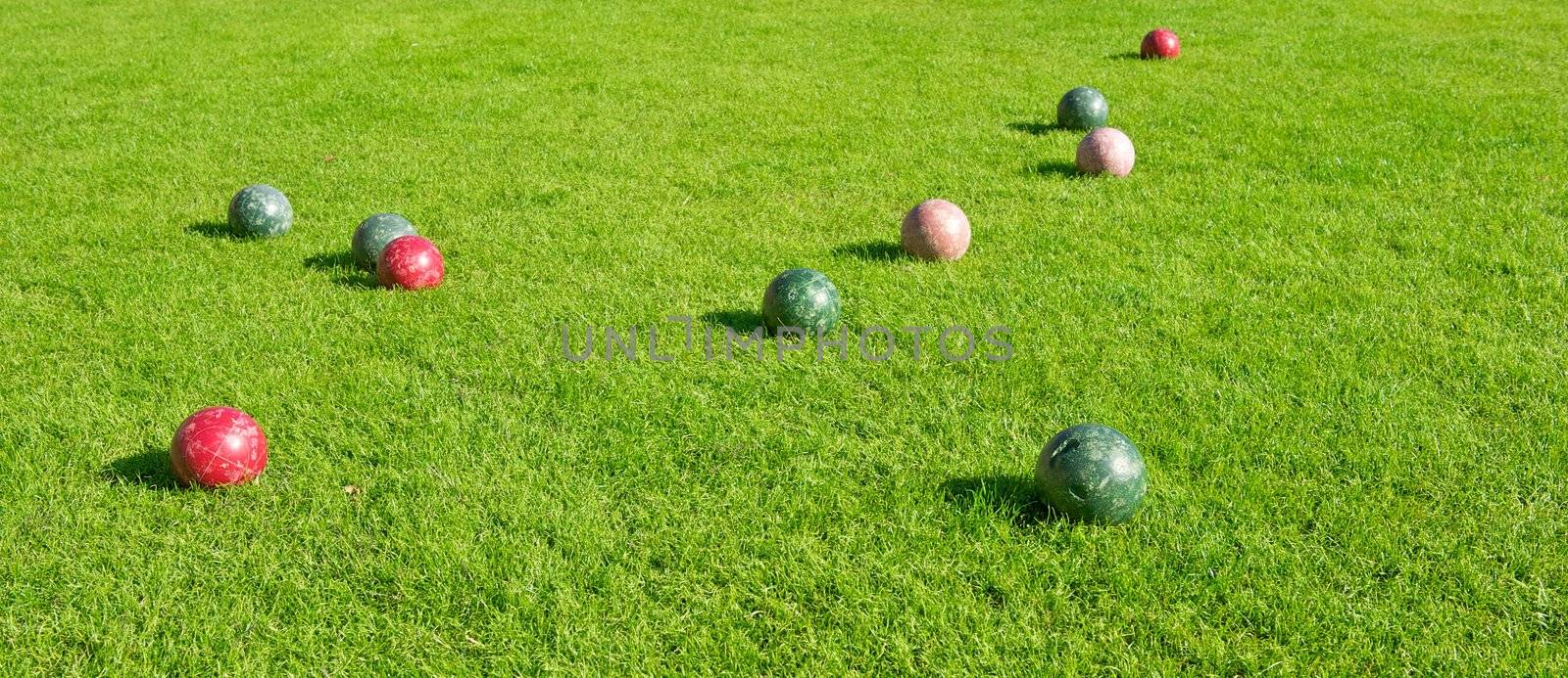Grassy Area with Bocce Balls Game by pixelsnap