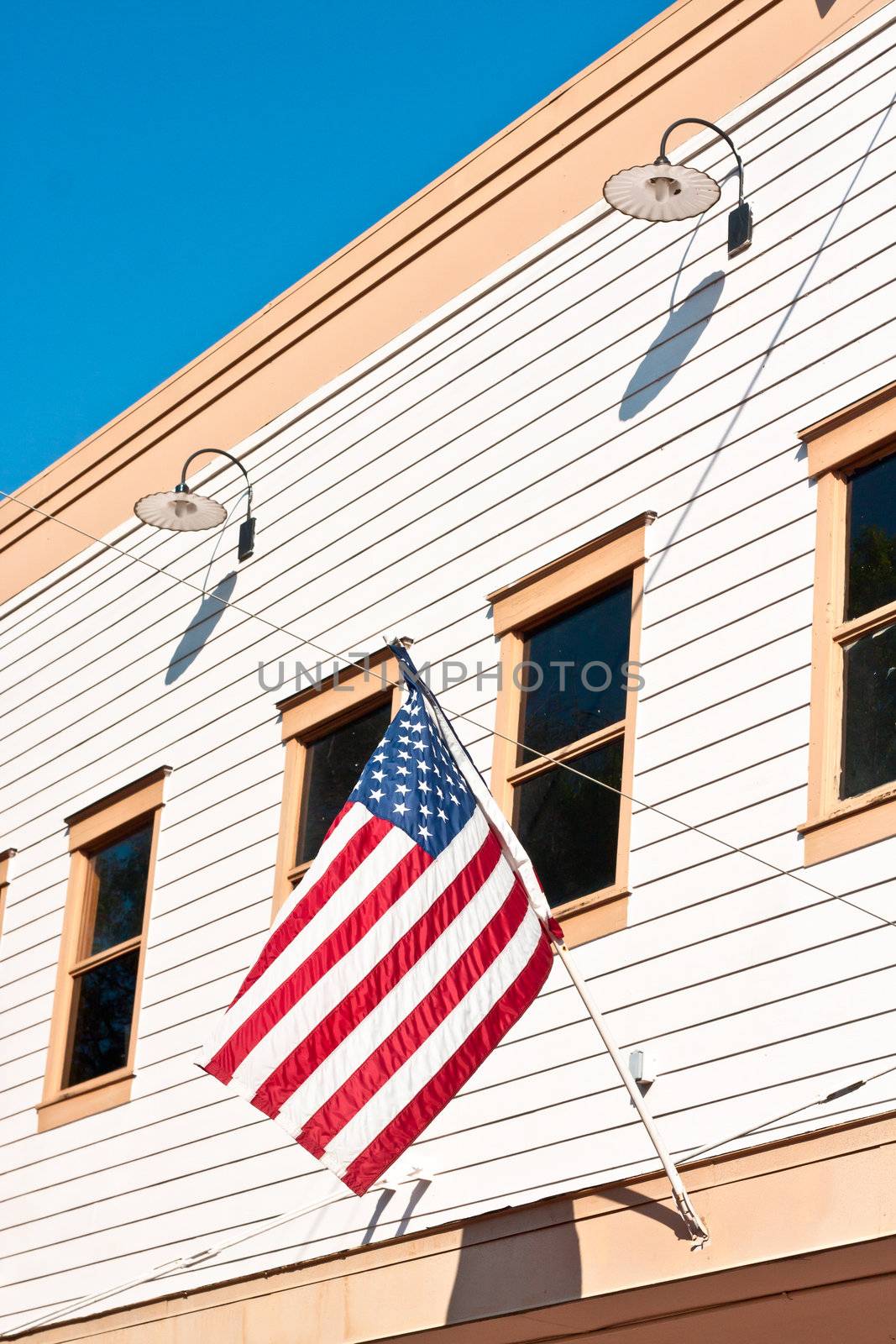 American flag attached to a small town building in the USA
