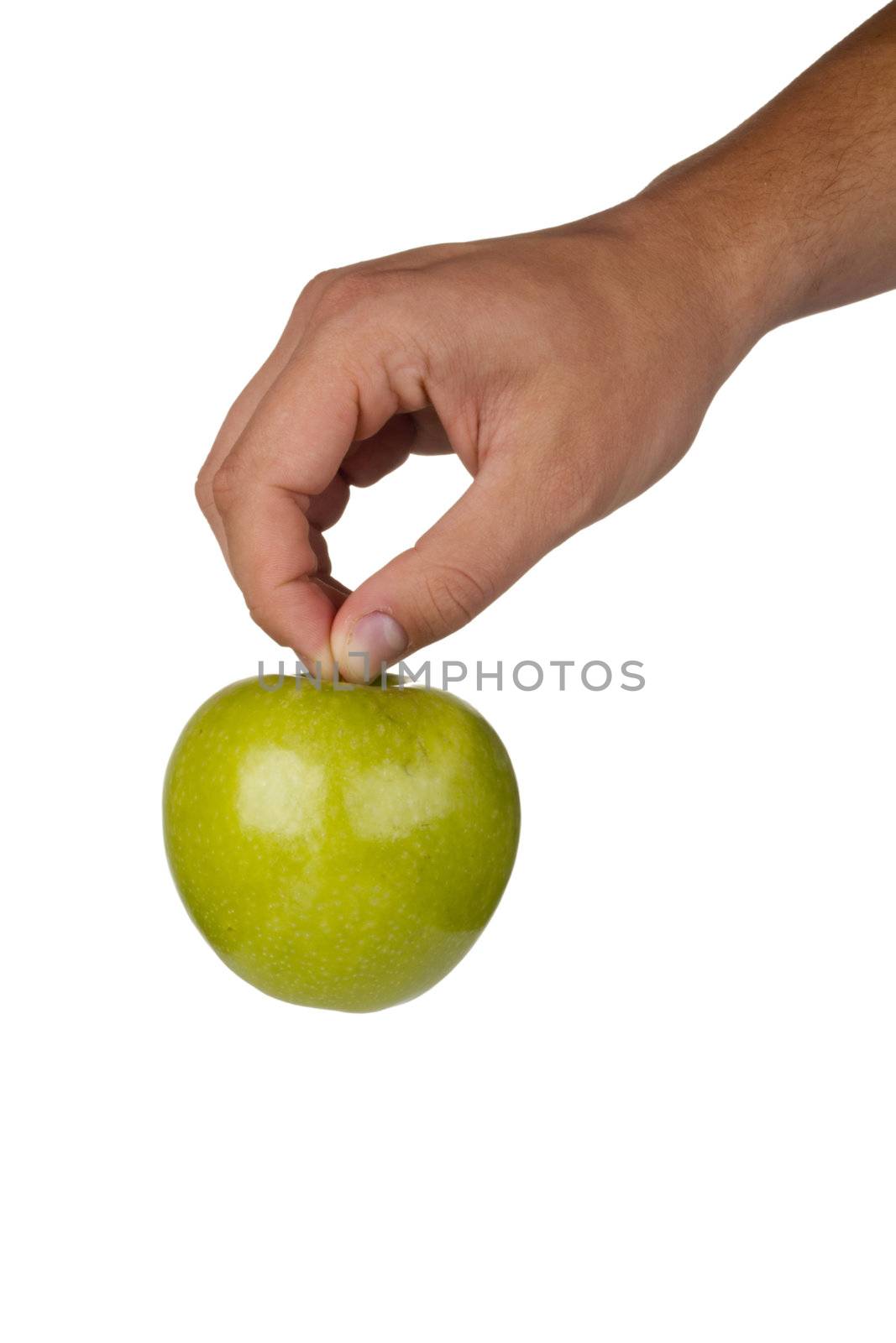 Green Granny Smith apple in a hand on a white background.