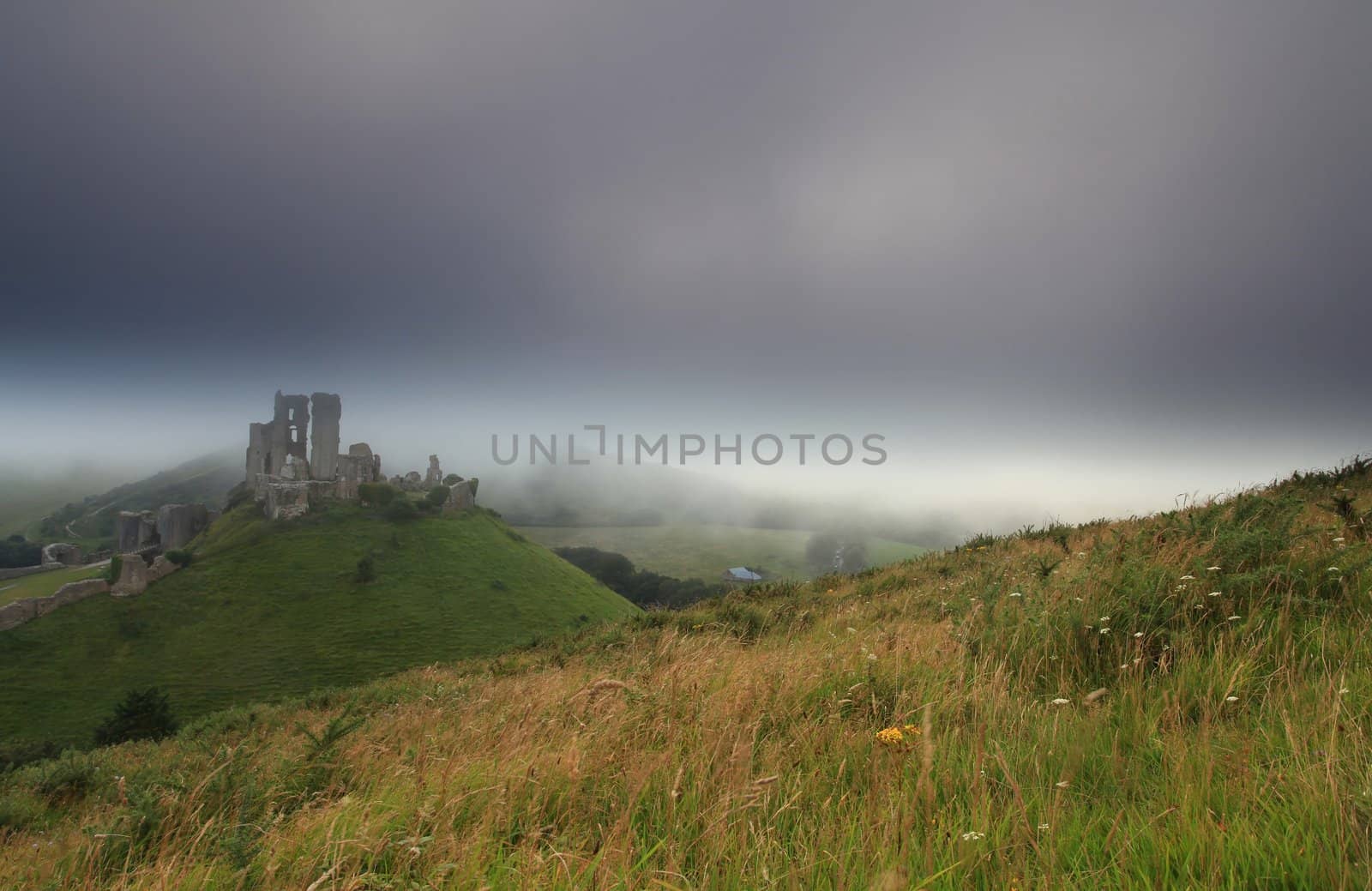 Norman dark ages castle ruin in dorset england in thick sea mist