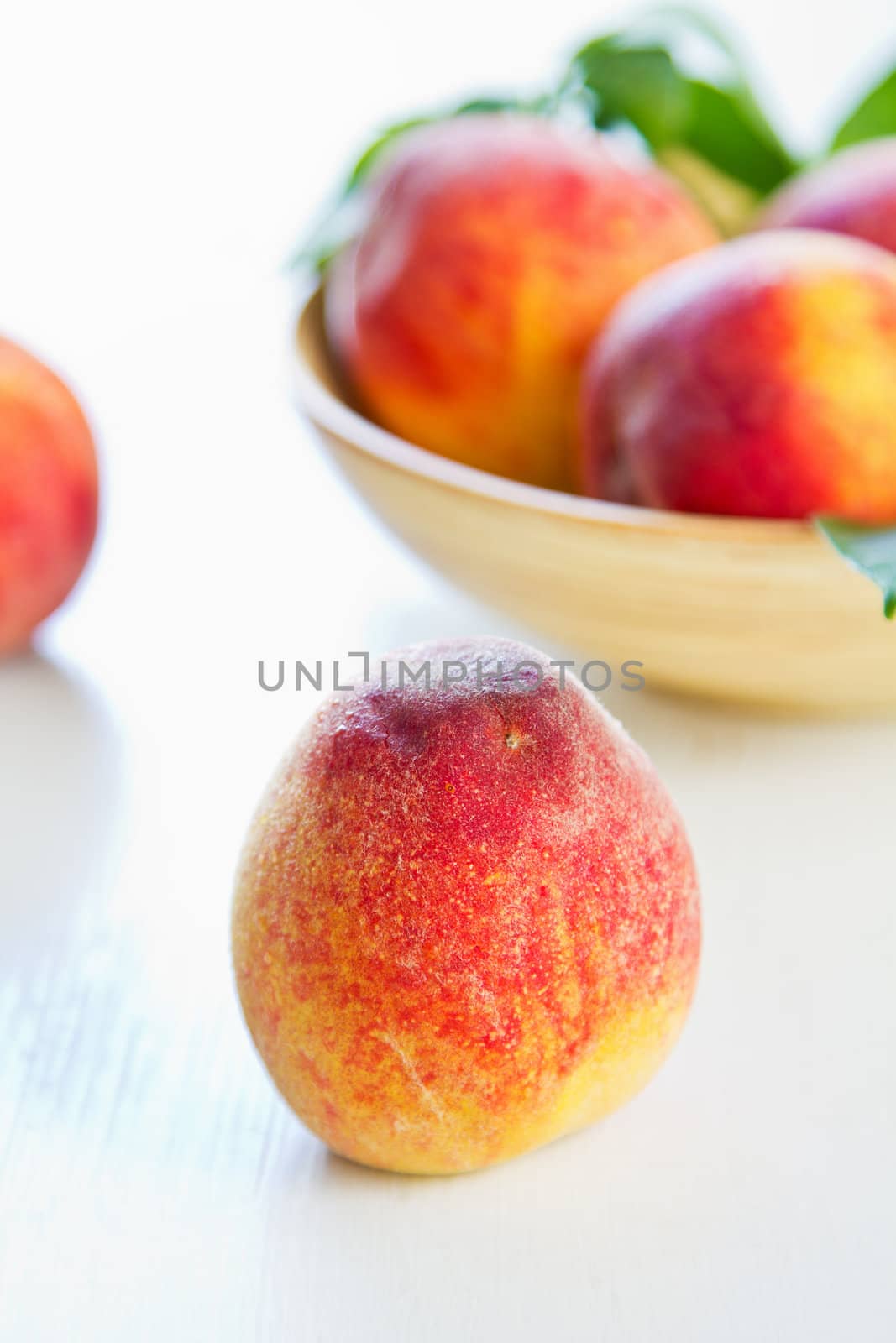 Fresh Peachs in wood bowl