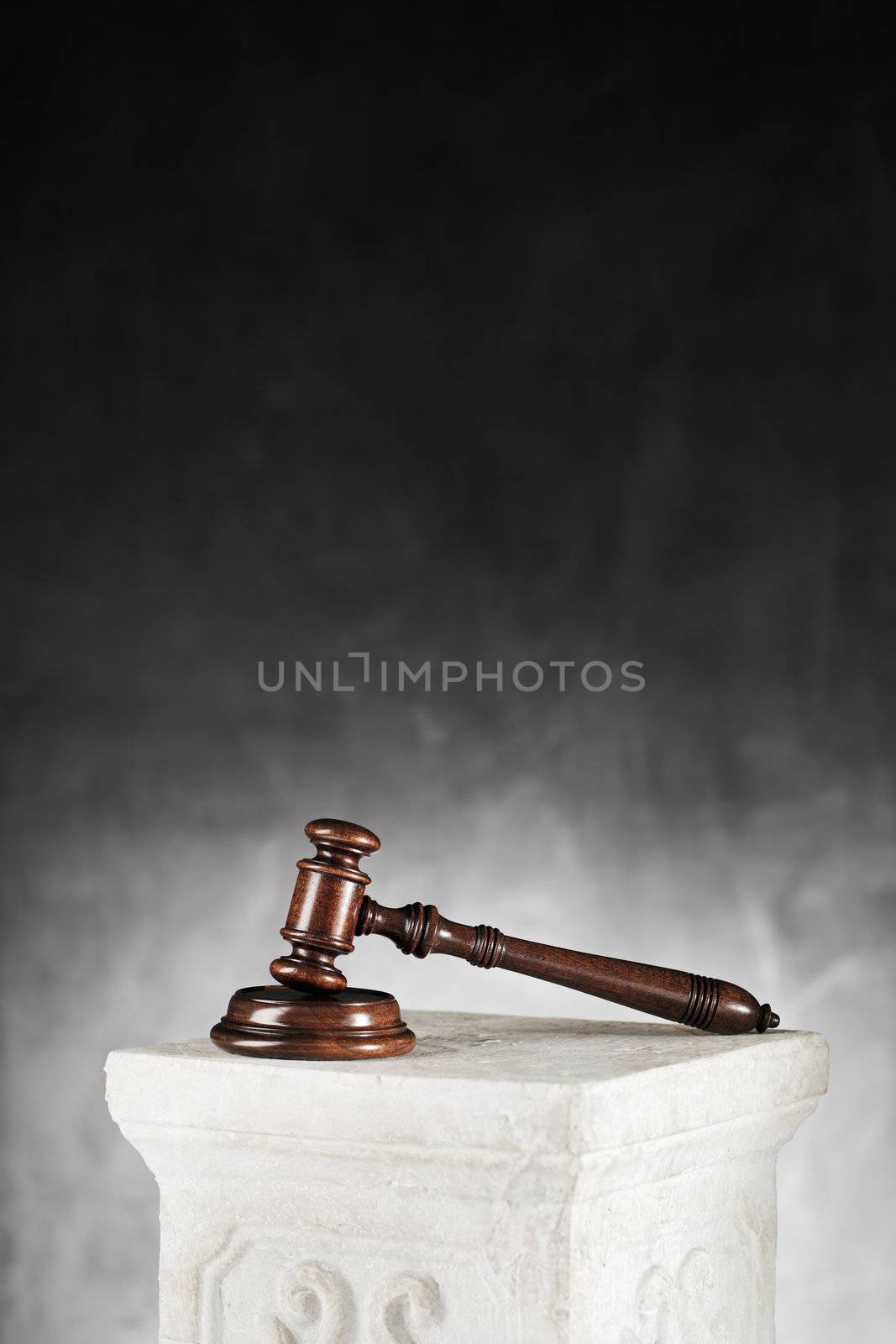 High quality mahogany gavel with sound block on a plaster column. 
