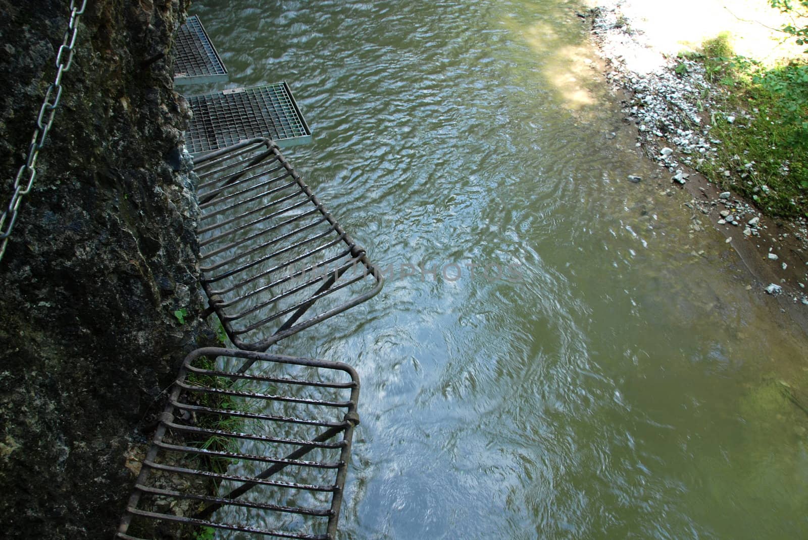 Extreme Adventure in Slovakian National Park Slovensky Raj. Climbing on slippery ledders over wild brook with waterfalls in Sokolia roklina canyon