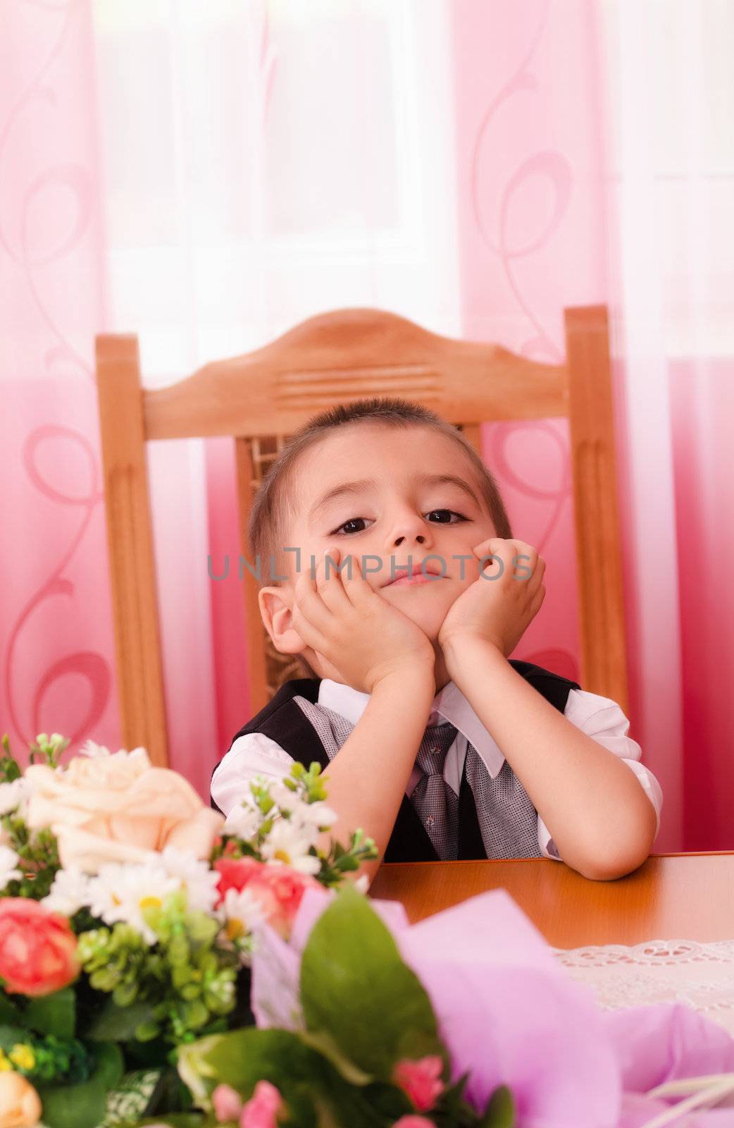 Little boy sitting on chair and thinking