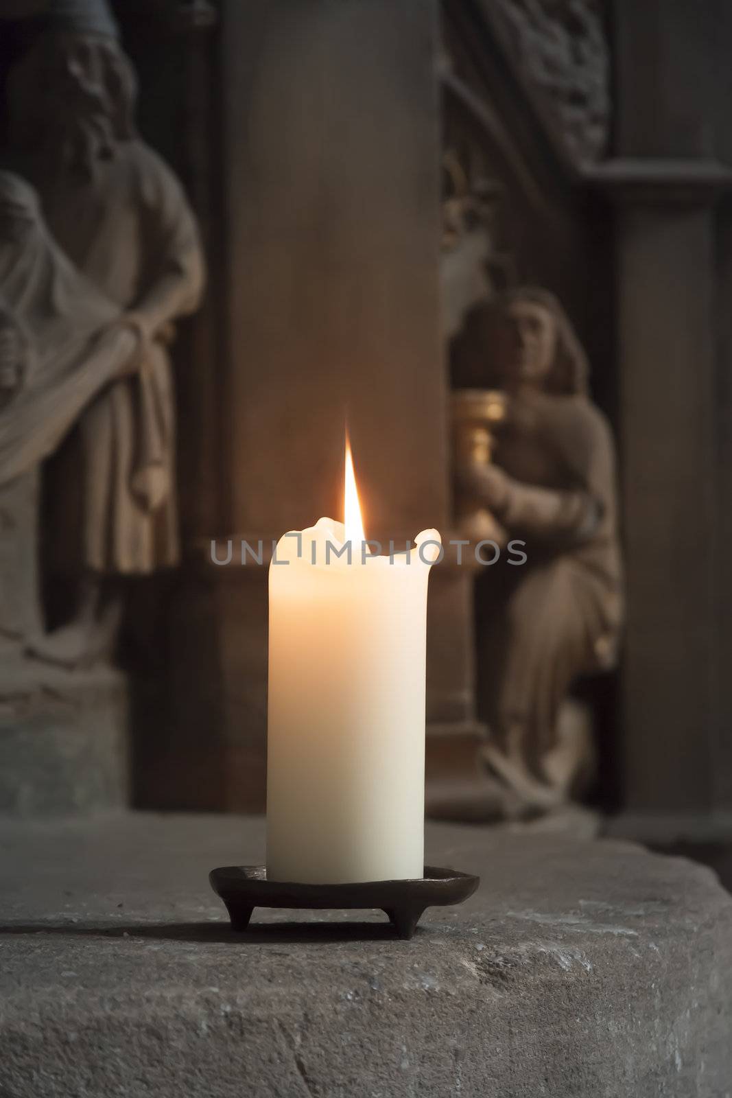 candle in a church by magann