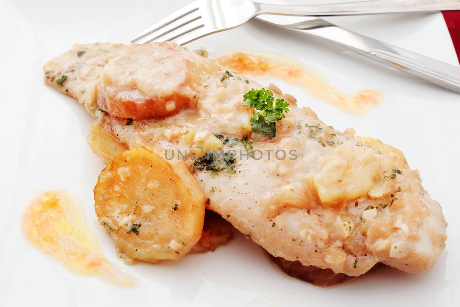 dish of hake cooked with sauce made with garlic onion parsley islet olive oil and white wine