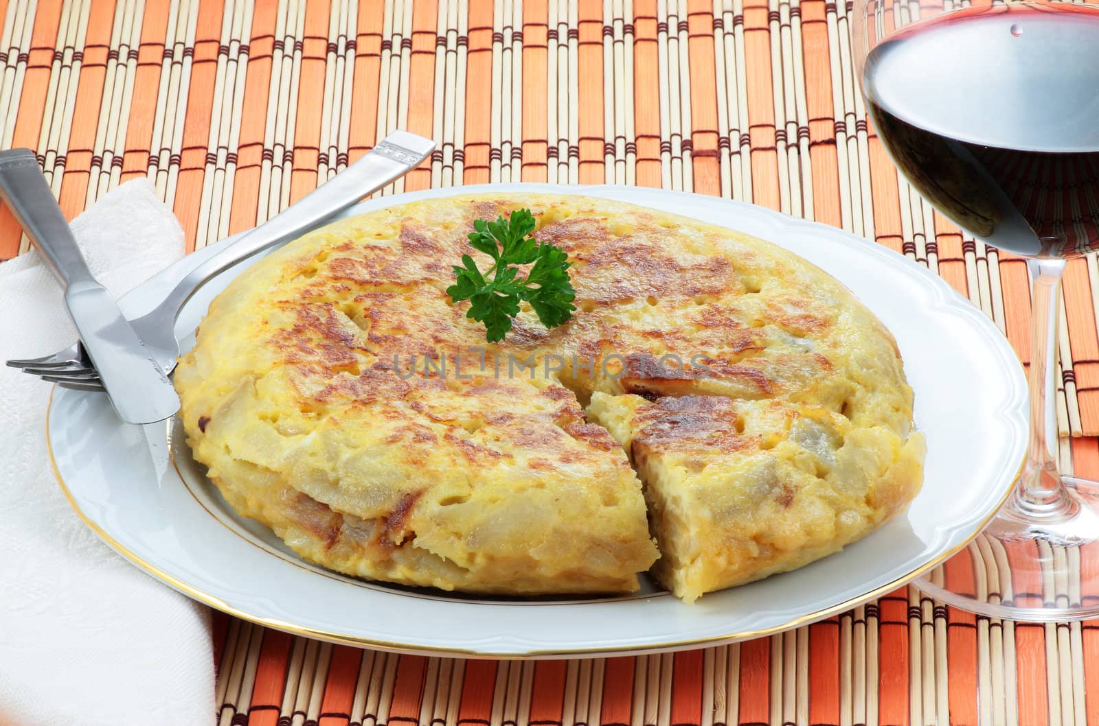 spanish omelet of potatoes and onion with a glass of red wine