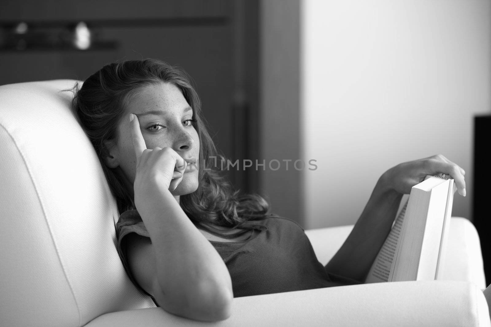 Portrait of a young beautiful woman reading a book