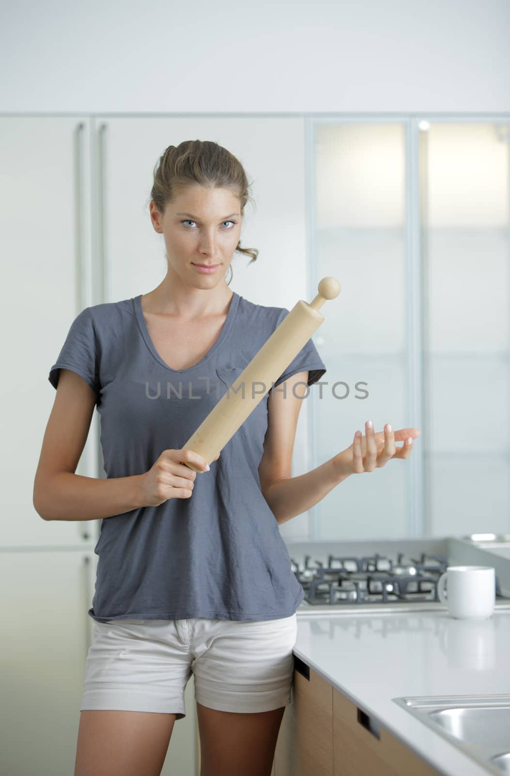 Angry housewife with rolling pin