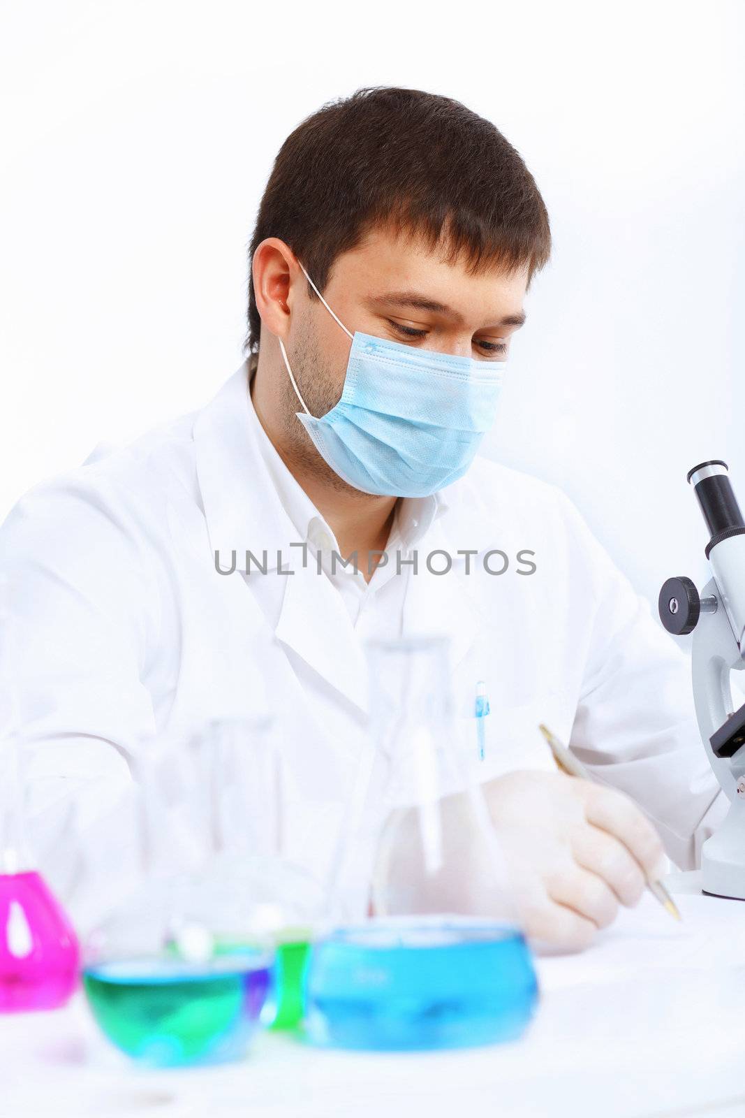 Young male scientist working in laboratory by sergey_nivens