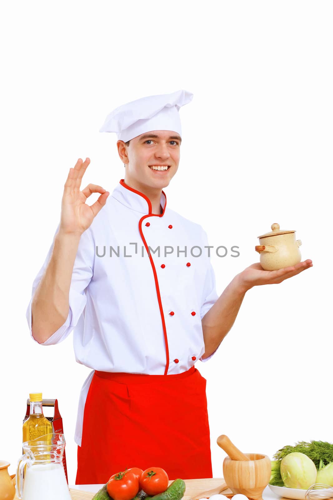 Young cook preparing food wearing a red apron