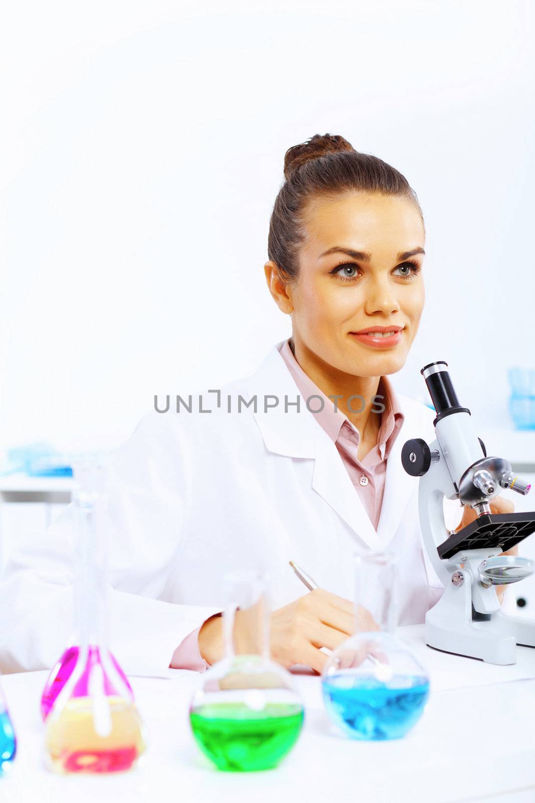 Young female scientist working in laboratory by sergey_nivens