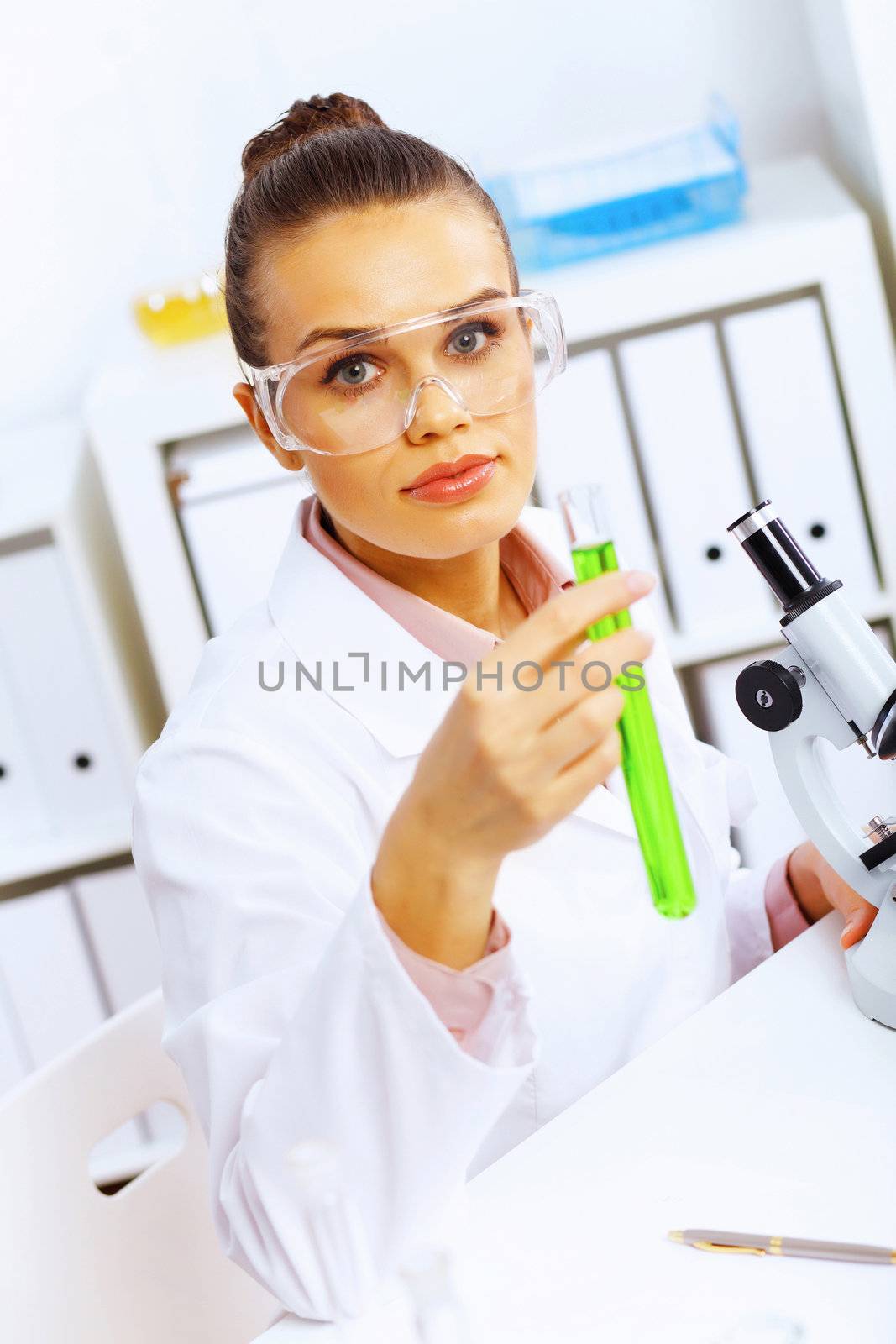 Young female scientist working in laboratory by sergey_nivens