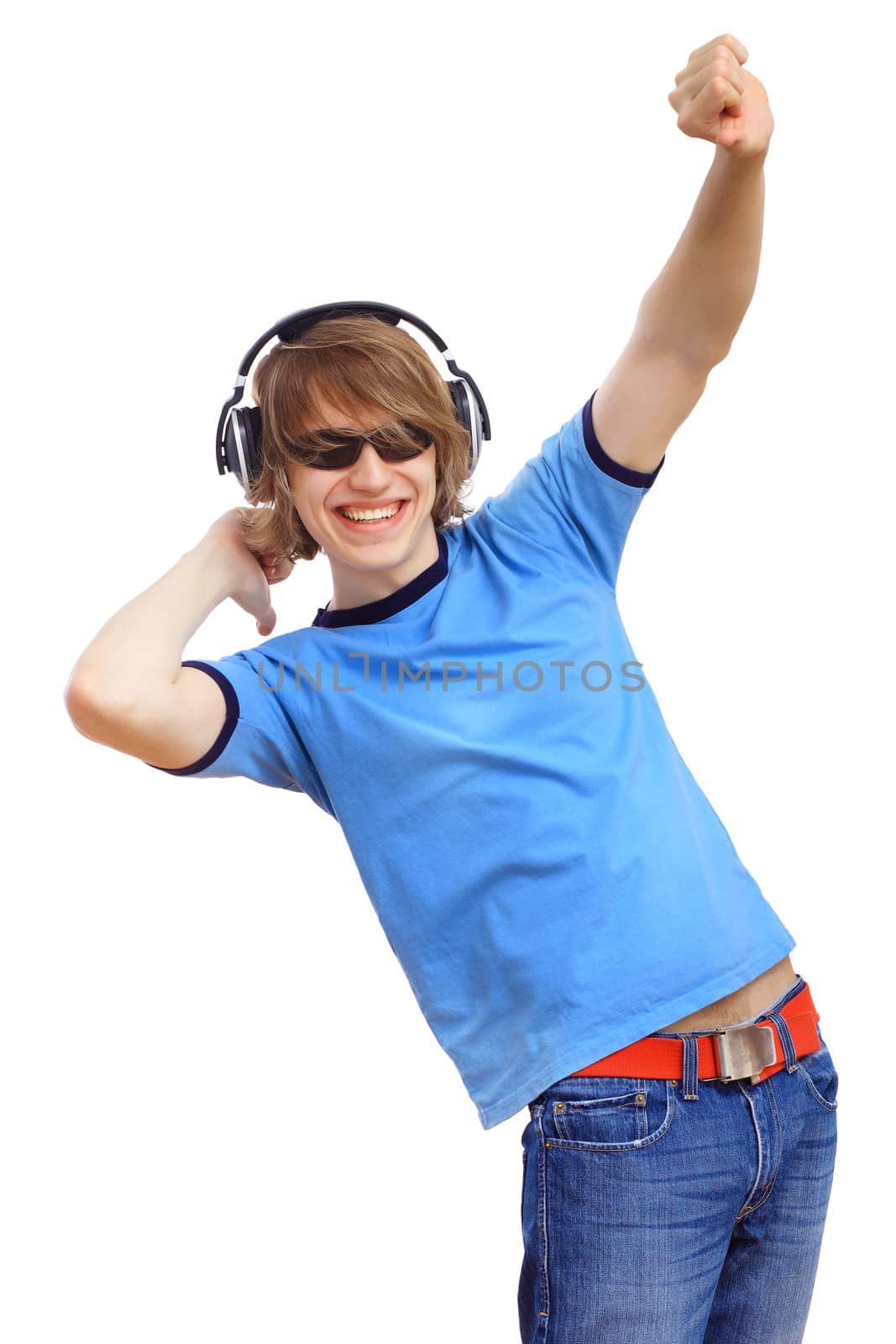 Happy smiling young man dancing and listening to music