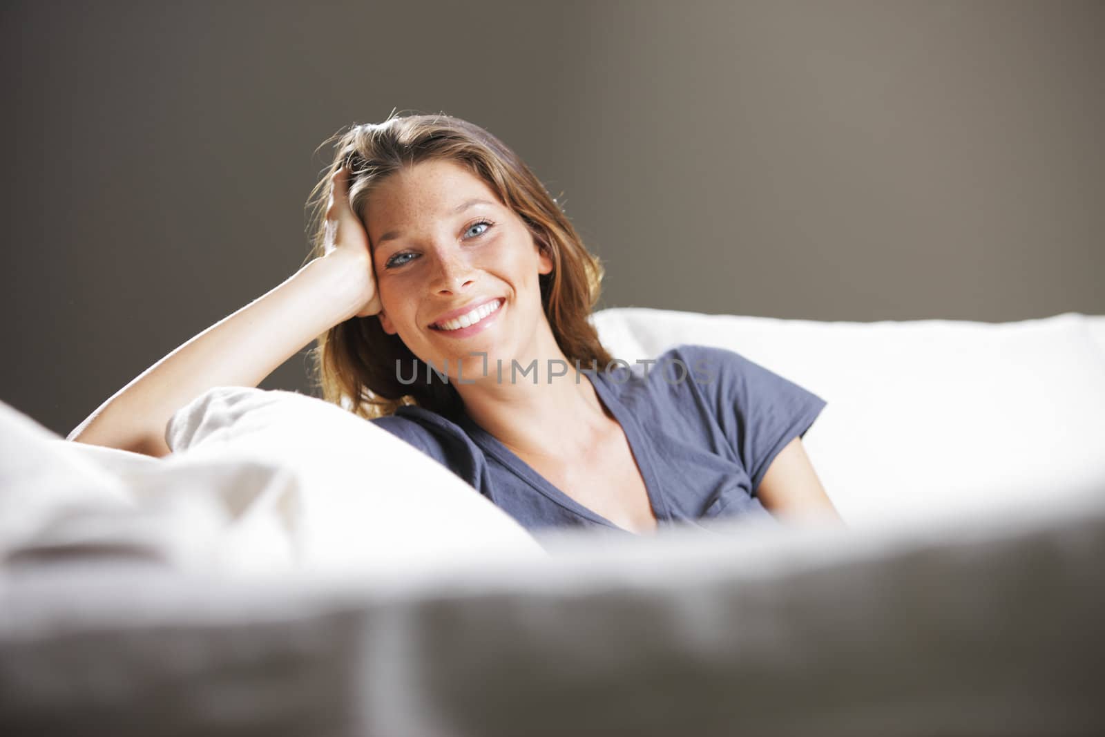 Portrait of beautiful young woman relaxing on couch 