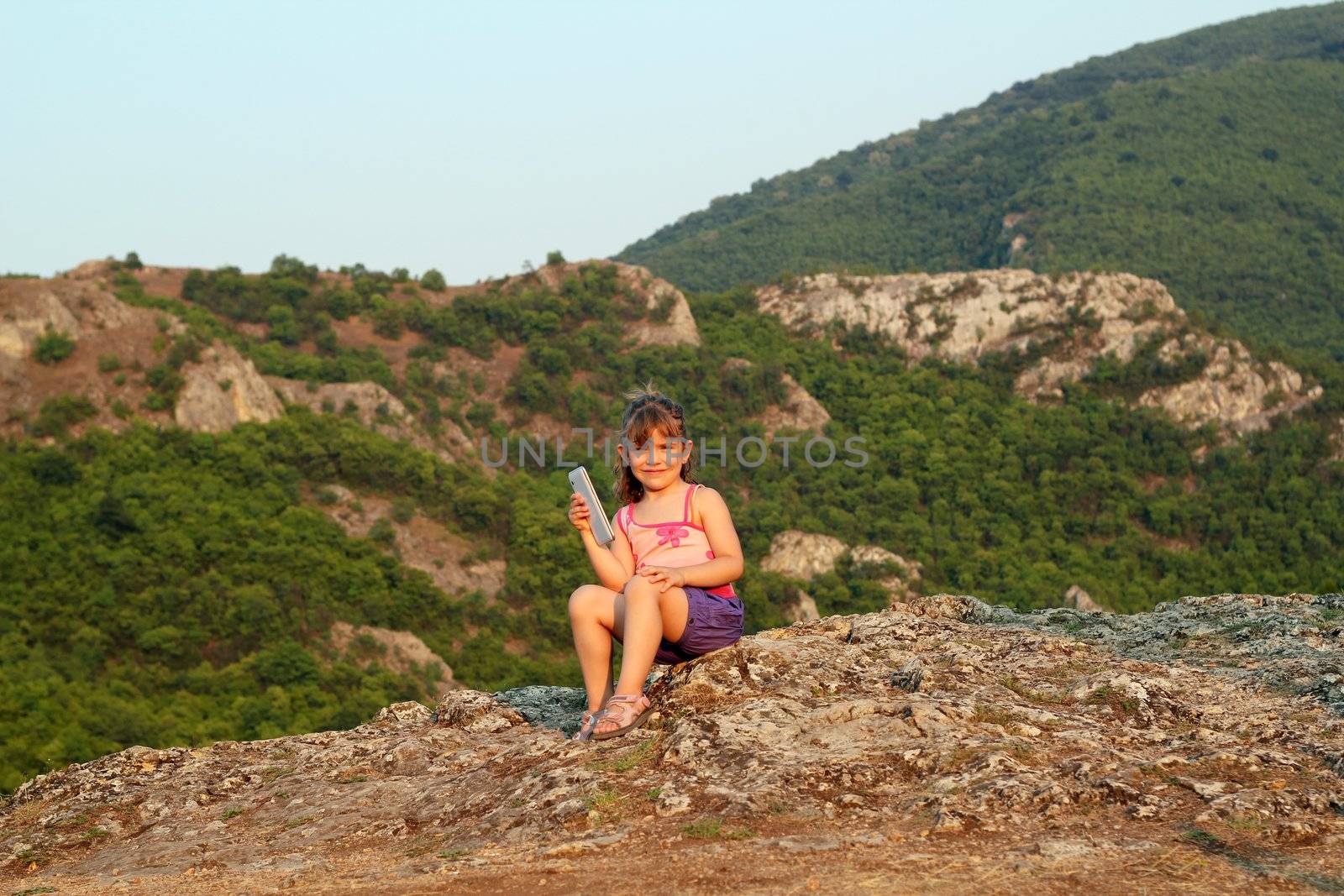 little girl holding tablet pc