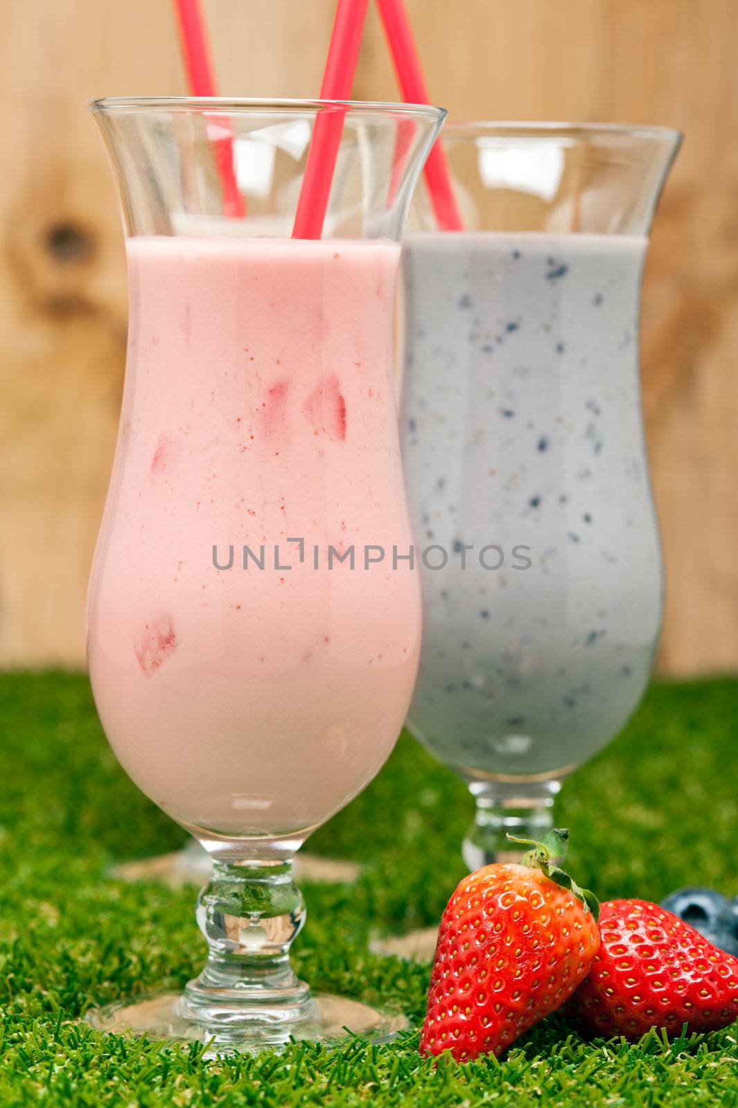 Blueberry and Strawberry milk shake with red straw