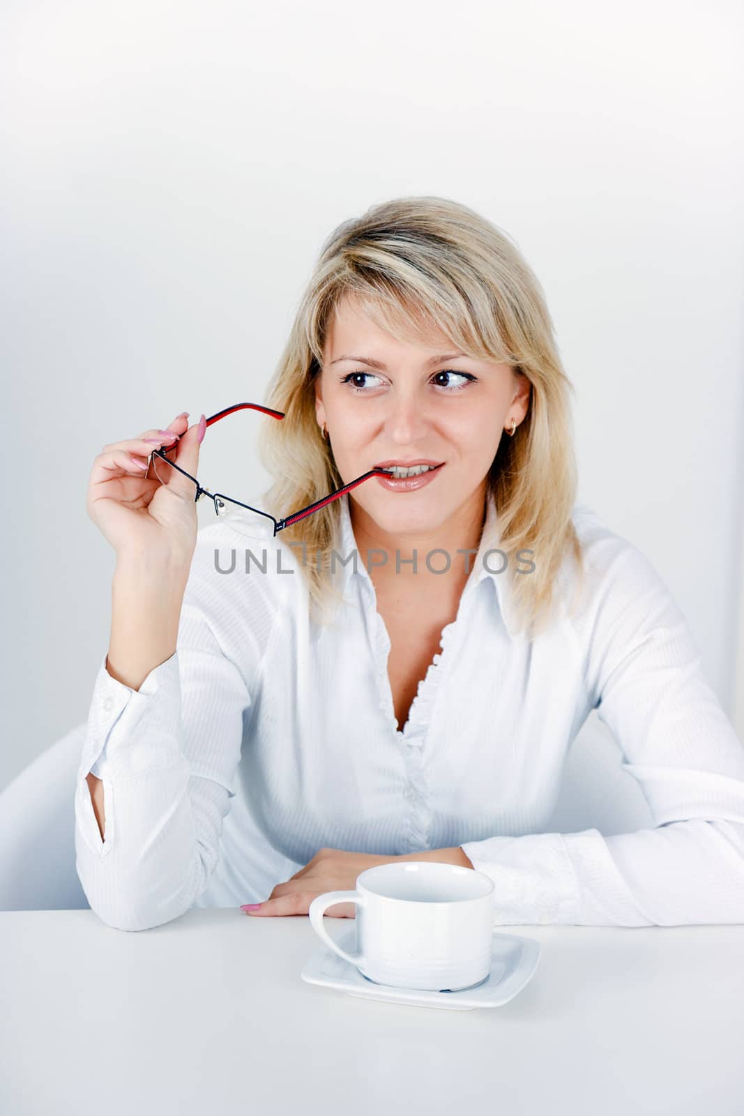 attractive blond girl with a cup of tea in the office