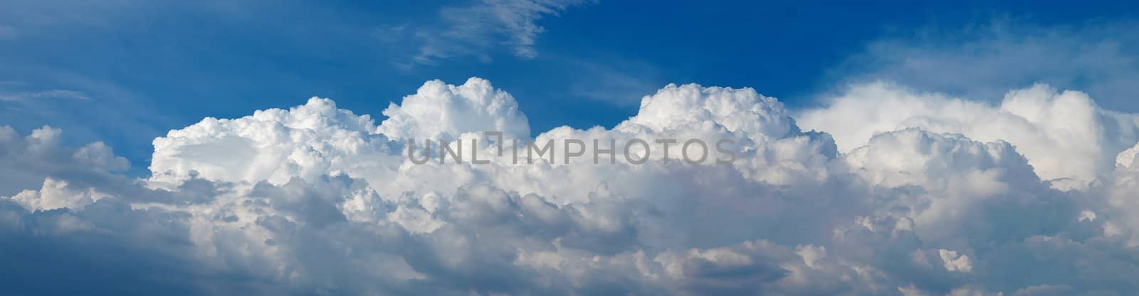 A panoramic shot of fluffy white cumulus clouds in the sky