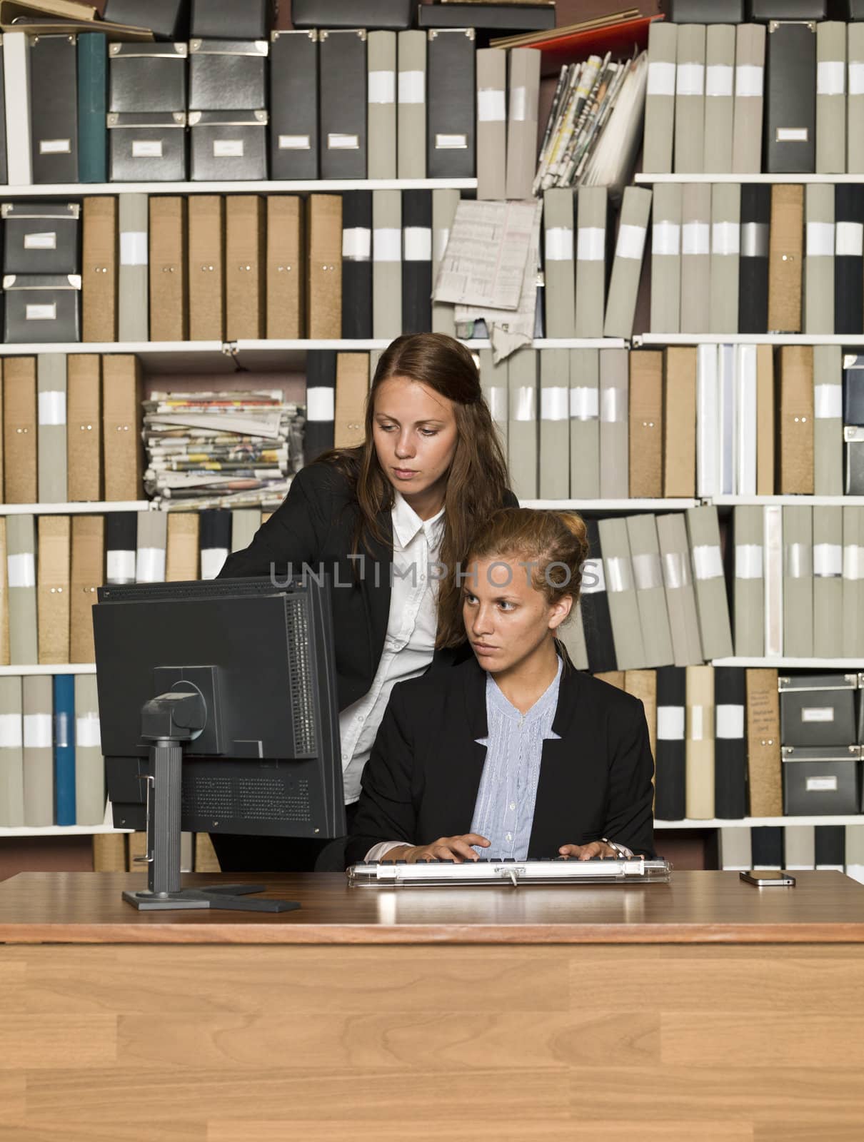Two businesswomen in front of a computer
